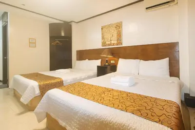 a hotel room with two beds in a room at The Shilla Philia Hotel by RedDoorz in Manila