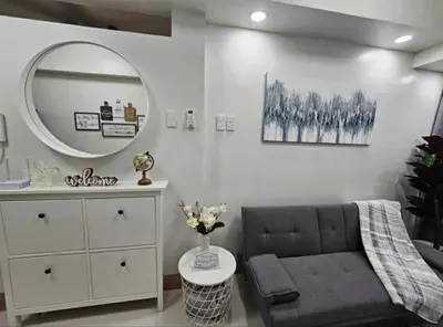 a living room with a couch and a mirror at New Crib at Shore 3 in Manila