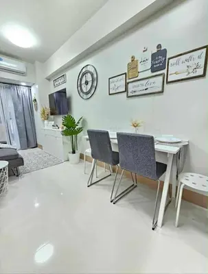 a living room with a white table and chairs at New Crib at Shore 3 in Manila