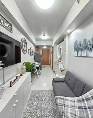 a living room with a couch and a tv at New Crib at Shore 3 in Manila