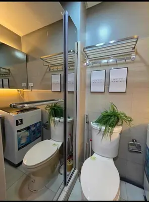 a bathroom with two toilets with plants on them at Sakura Suite at Shore 2 in Manila
