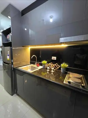 a kitchen with a sink and a counter with plants at Sakura Suite at Shore 2 in Manila