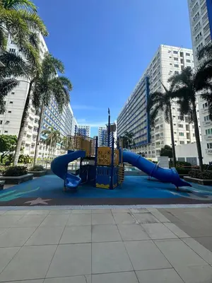 a playground with a slide in a city at The Luxe Stay at Sea Residences in Manila