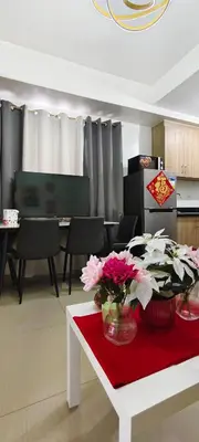 a living room with a table with flowers on it at Stand out and cozy condo unit at Shore 2 Tower 3 in Manila