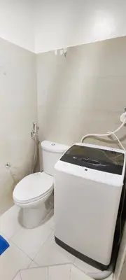 a white bathroom with a toilet and a toaster at Stand out and cozy condo unit at Shore 2 Tower 3 in Manila