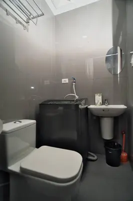 a bathroom with a white toilet and a sink at The Dream Scape SMDC Air Residences Makati in Manila