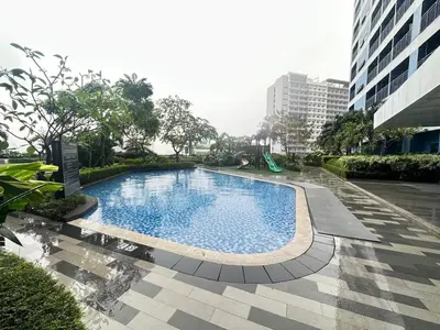 a large swimming pool in the middle of a building at The Dream Scape SMDC Air Residences Makati in Manila