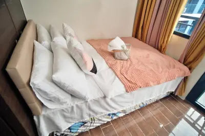 a bed with pillows on it with at The Dream Scape SMDC Air Residences Makati in Manila