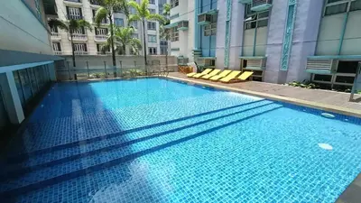 a large blue swimming pool in a building at Manila Airport Hub near NAIA T3 -101 Newport Boulevard in Manila