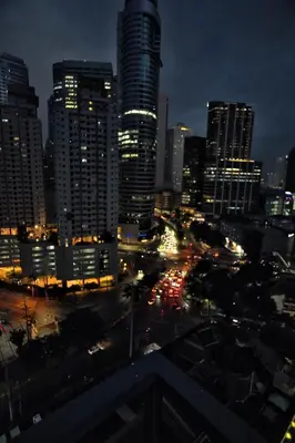 a city skyline at night with traffic on a street at The Urban Crib SMDC Residences Makati in Manila