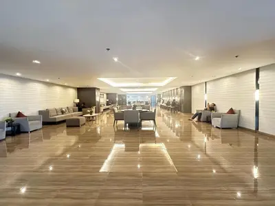 a lobby with couches and tables in a building at The Urban Crib SMDC Residences Makati in Manila