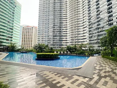 a large swimming pool in front of a large building at The Urban Crib SMDC Residences Makati in Manila