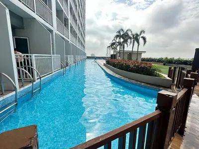 a swimming pool in the middle of a building at Sweet Villa SMDC Breeze Residences Pasay in Manila