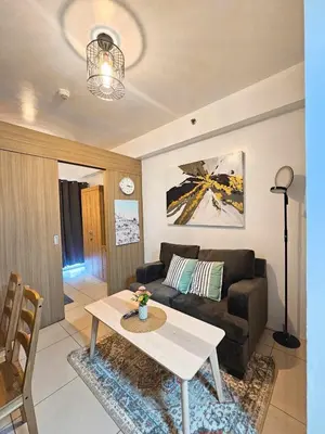 a living room with a couch and a table at Sweet Villa SMDC Breeze Residences Pasay in Manila