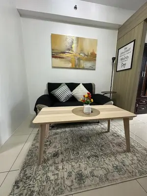 a coffee table in a living room with a couch at Sunset heights SMDC Breeze Residences Pasay in Manila