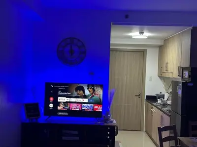 a blue room with a television in a kitchen at Pyeong on Suite SMDC Shore Residences Mall of Asia Pasay in Manila