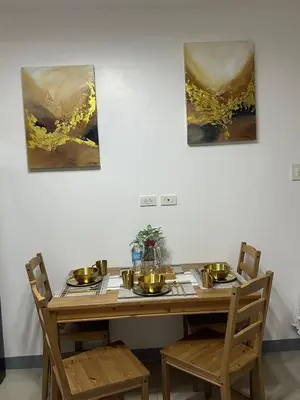 a dining room table with plates and bowls on it at Pyeong on Suite SMDC Shore Residences Mall of Asia Pasay in Manila