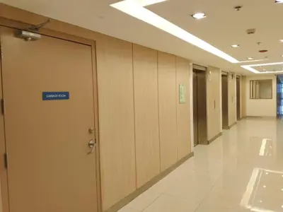 an office hallway with a door with a sign on it at S Residences Tower 1 - near MOA & Ayala Malls Manila Bay in Manila