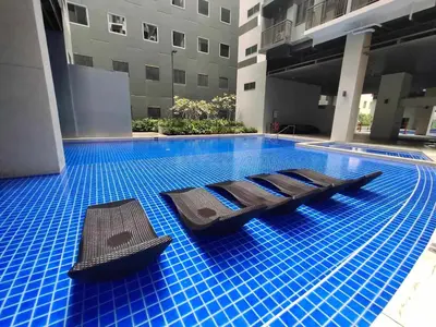 a swimming pool with blue tiles in a building at S Residences Tower 1 - near MOA & Ayala Malls Manila Bay in Manila