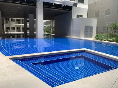 a swimming pool with blue tiles in a building at S Residences Tower 1 - near MOA & Ayala Malls Manila Bay in Manila