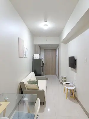a living room with a couch and a table at S Residences Tower 1 - near MOA & Ayala Malls Manila Bay in Manila