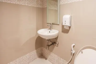 a bathroom with a sink and a mirror at Hotel Sogo Baclaran in Manila