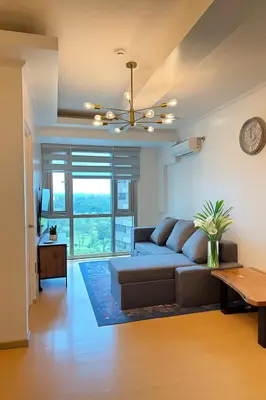 a living room with a couch and a table at Avant BGC 2 Bedroom in Manila
