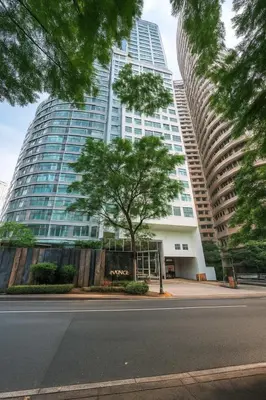 a tall building with a tree in front of it at Avant BGC 2 Bedroom in Manila