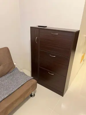 a wooden dresser with a bed in a room at Osaka Theme LRT Gilmore Robinsons Magnolia Free Netflix Internet Pool in Manila