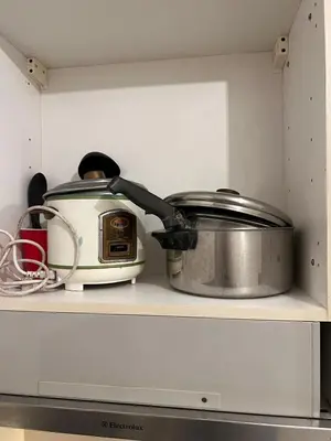 a slow cooker and a toaster sitting on a shelf at Osaka Theme LRT Gilmore Robinsons Magnolia Free Netflix Internet Pool in Manila