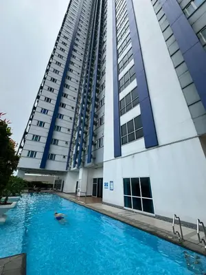a building with a swimming pool in front of a building at Osaka Theme LRT Gilmore Robinsons Magnolia Free Netflix Internet Pool in Manila