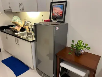 a small kitchen with a sink and a refrigerator at Osaka Theme LRT Gilmore Robinsons Magnolia Free Netflix Internet Pool in Manila