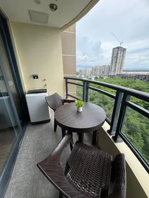 a balcony with a table and chairs on a balcony at Sy bay Suites TwinBed near Okada MOA PITX NAIA cod MSV1502H in Manila