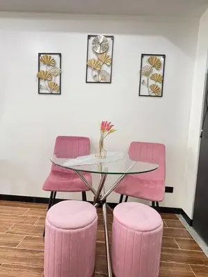a dining room with pink chairs and a glass table at Sy bay Suites TwinBed near Okada MOA PITX NAIA cod MSV1502H in Manila