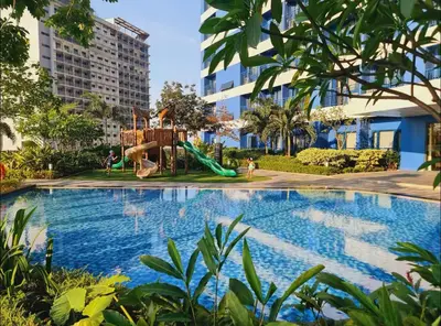 a swimming pool with a playground and a slide at Cozy Escape by Dave 4265 in Manila