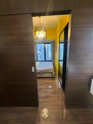 a hallway with a room with a bed and a chandelier at Cozy Escape by Dave 4265 in Manila