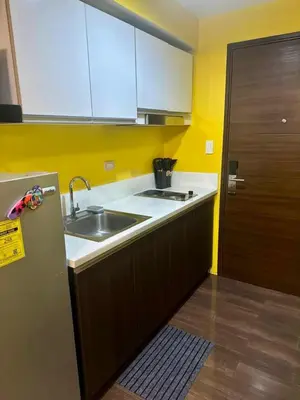 a small kitchen with a sink and a refrigerator at Cozy Escape by Dave 4265 in Manila