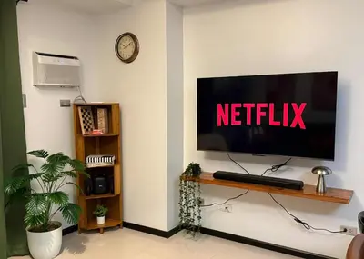 a television on a wall with the netflix sign on it at Casa Forma in Manila