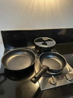 two pans sitting on top of a stove at Casa Forma in Manila