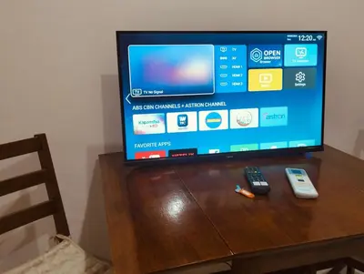 a television sitting on top of a wooden table at #Affordable Condotel Newport Boulevard in Manila