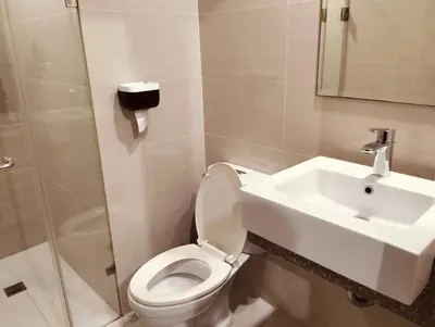 a bathroom with a toilet and a sink at #Affordable Condotel Newport Boulevard in Manila