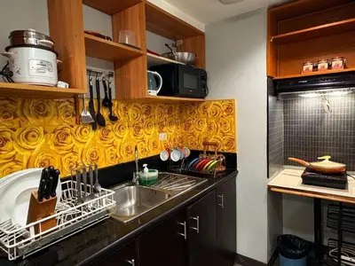 a kitchen with a sink and a counter top at Super Cozy Apartment-Newport Boulevard in Manila