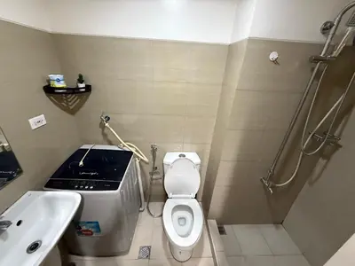 a bathroom with a toilet and a sink and a shower at Shell and Shorline Bliss Manila Staycation in Manila