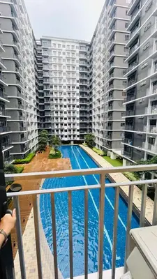 a view of a swimming pool from a balcony of a apartment at Lana Haven in Manila