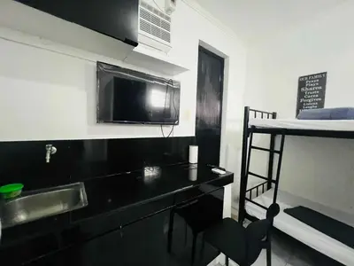 a small kitchen with a sink and a microwave at T&A Building in Manila
