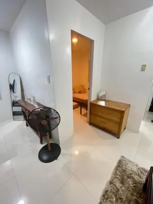a room with a chair and a mirror on the floor at Motorists Transient House in Carmona