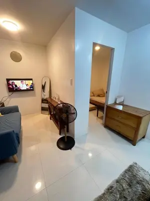 a living room with a desk and a bedroom at Motorists Transient House in Carmona