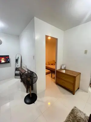 a room with a chair and a desk and a bed at Motorists Transient House in Carmona