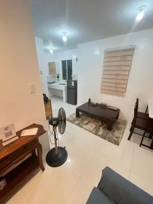 a living room with a couch and a table at Motorists Transient House in Carmona