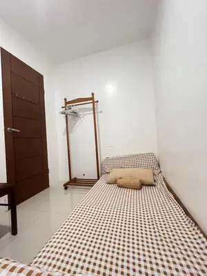 a bedroom with a bed with a checkered mattress at Motorists Transient House in Carmona